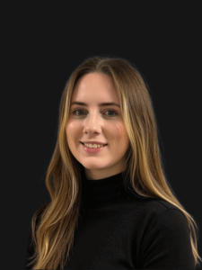 Professional photo of Ally, administrative employment specialist. She is a young woman with lightly colored hair. She is dressed in business professional clothes. 