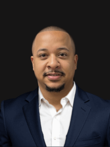 Professional photo of Eric, industrial employment specialist. He is a young man with dark hair. He is dressed in business professional clothes. 