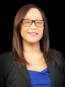 Professional photo of a female recruiter with brown hair wearing glasses, a blue blouse, and a black blazer