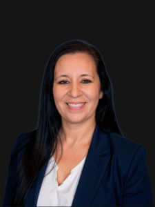 Professional photo of Gina, senior employment specialist and office manager. She is a middle-aged woman with dark colored hair. She is dressed in business professional clothes. 