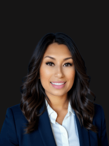 Professional photo of Gloria. She is a middle aged woman with dark colored hair. She is dressed in professional business attire.