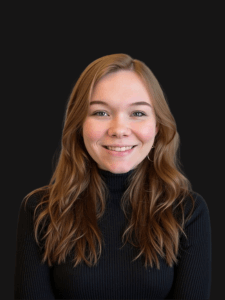 Professional photo of Madison dressed in professional attire. Madison is a young woman with lightly colored hair. 