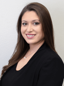 Professional photo of a female recruiter with long brown hair wearing a black top and blazer