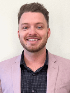 Professional photo of a young man in a pink blazer and a black button-down