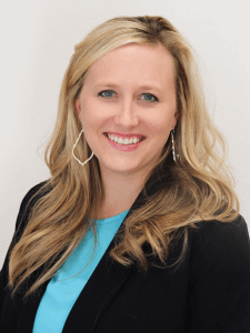 Professional photo of a female light industrial recruiter with blonde hair wearing a light blue top and black blazer