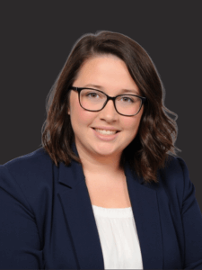 Professional photo of Haley. She is a middle-aged woman with dark hair. She is dressed in business professional attire.