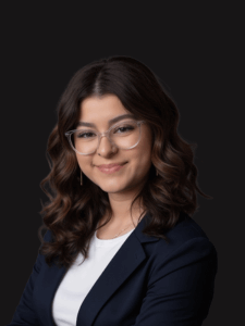 Professional photo of Felicia. Felicia is a young woman with dark hair. She is dressed in business professional attire.