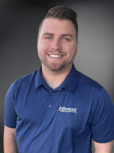 Professional photo of a young male Light Industrial and Skilled Trades recruiter with short brown hair and a blue Express shirt